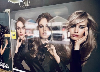 Entrance of Glitz Beauty Center in Dubai, AE featuring chic L'Oreal promotional models.