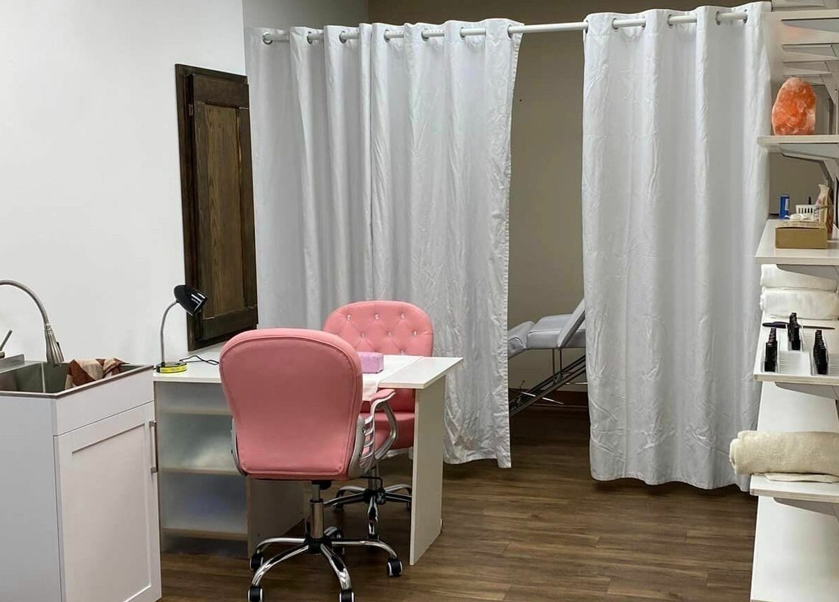 Welcoming treatment room at Wisdom Health Holistic Wellness Center, Wainwright, Alberta, CA with pink chairs.