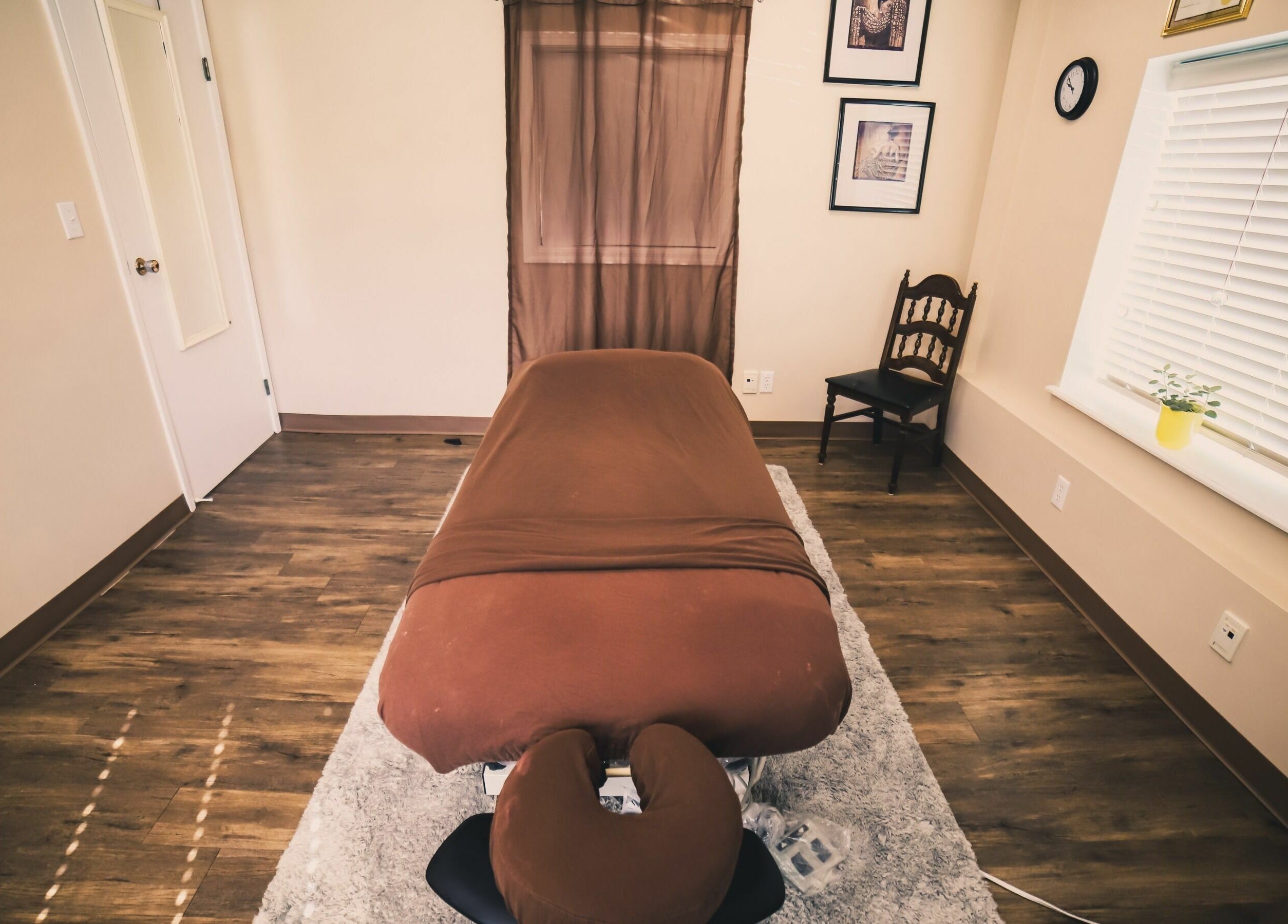 Calm massage room at Wisdom Health Holistic Wellness Center, Wainwright, Alberta, CA, with a cozy massage table.