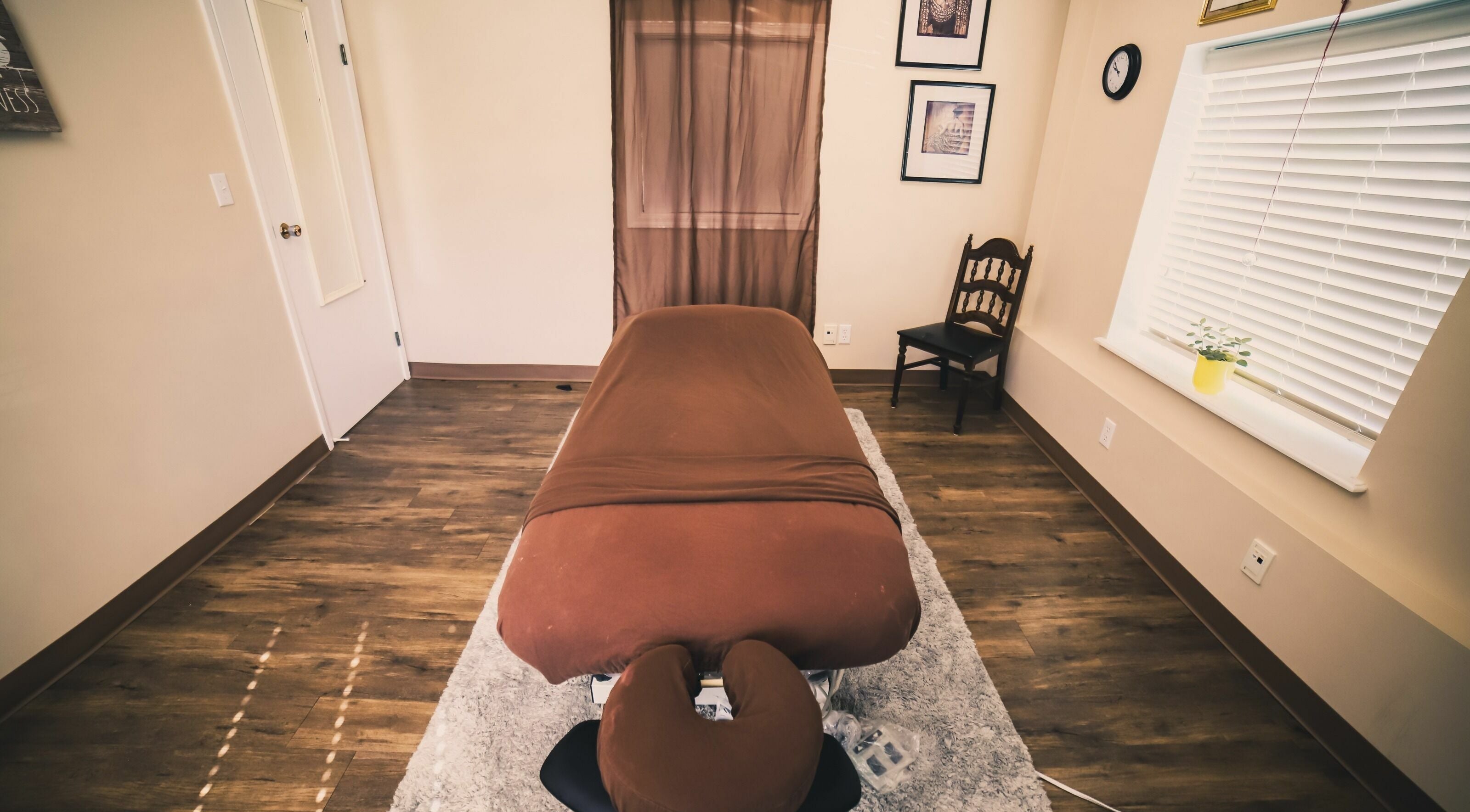 Calm massage room at Wisdom Health Holistic Wellness Center, Wainwright, Alberta, CA, with a cozy massage table.