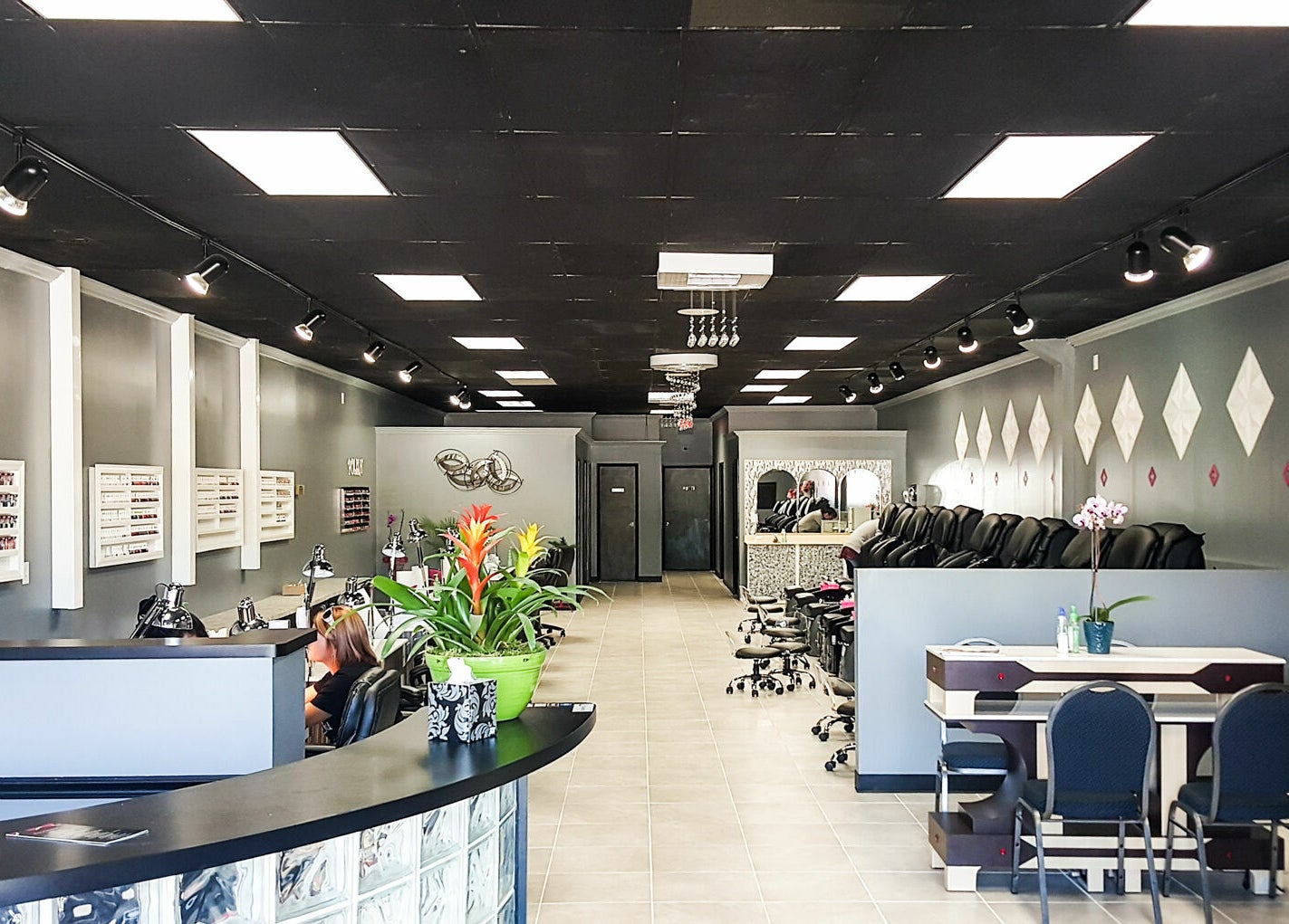 Interior of Golden Honey Nails and Spa in Parma Heights, Ohio, US, featuring sleek nail stations and elegant decor.