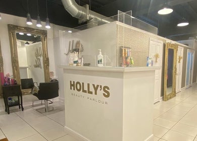 Inside Holly’s Beauty Parlour, Romford, England, GB, showcasing chic mirrors and stylish decor.