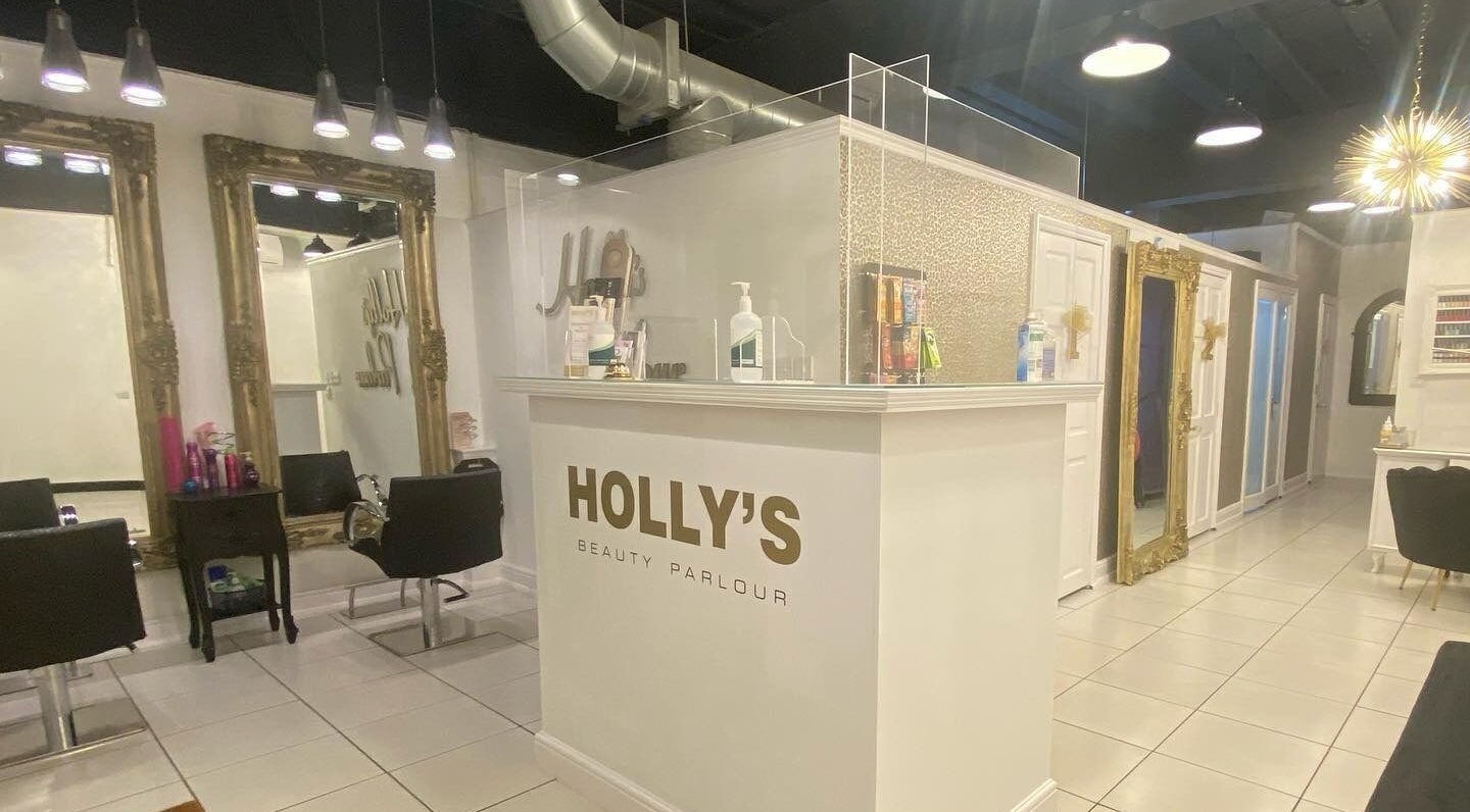 Inside Holly’s Beauty Parlour, Romford, England, GB, showcasing chic mirrors and stylish decor.