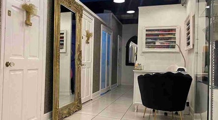 Interior of Holly’s Beauty Parlour in Romford, England, featuring a grand mirror and serene decor.