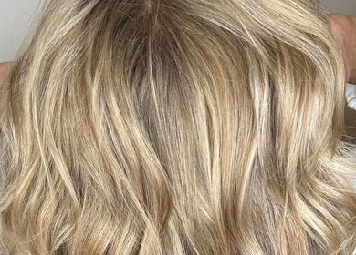 Elegant blonde hair styled at Holly’s Beauty Parlour, Romford, England, GB, showcasing vibrant color and texture.