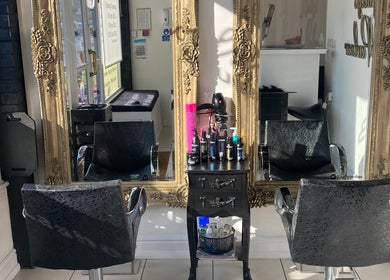 Elegant salon chairs and ornate mirrors at Holly’s Beauty Parlour, Romford, England, GB.