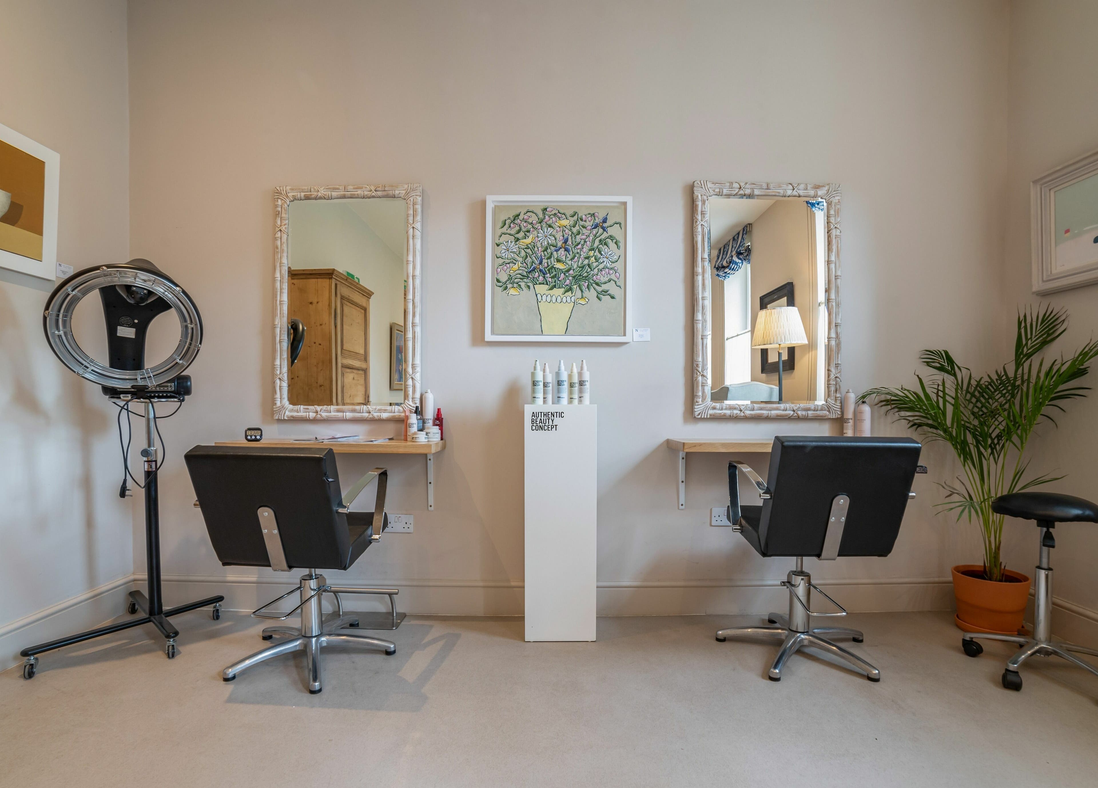Chic salon setup at Elcot Park Retreat in Newbury, England, GB featuring modern styling chairs and elegant decor.
