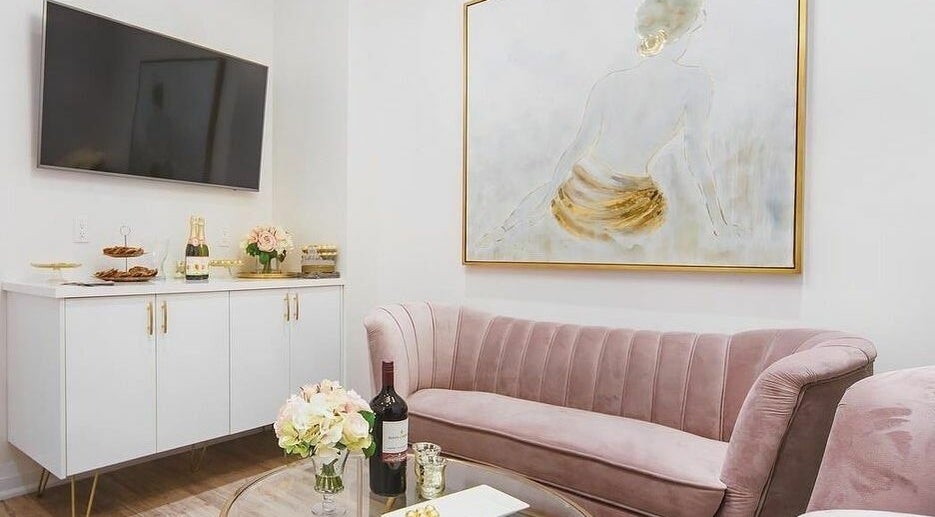 Luxurious lounge at Fusionmed Cosmetic (DT), Toronto, Ontario, CA featuring plush seating and elegant decor.