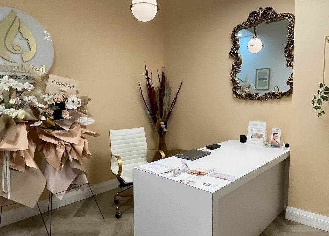 Elegant reception area at Fusionmed Cosmetic (DT), Toronto, Ontario, CA, showcasing chic decor and floral arrangement.