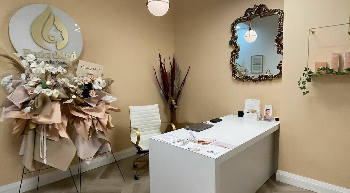 Elegant reception area at Fusionmed Cosmetic (DT), Toronto, Ontario, CA, showcasing chic decor and floral arrangement.