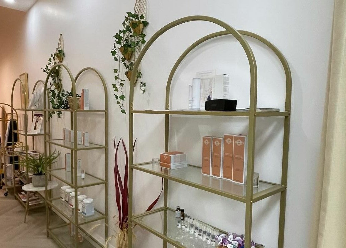 Chic shelving with products at Fusionmed Cosmetic (DT), Toronto, Ontario, CA. Aesthetic wellness design.