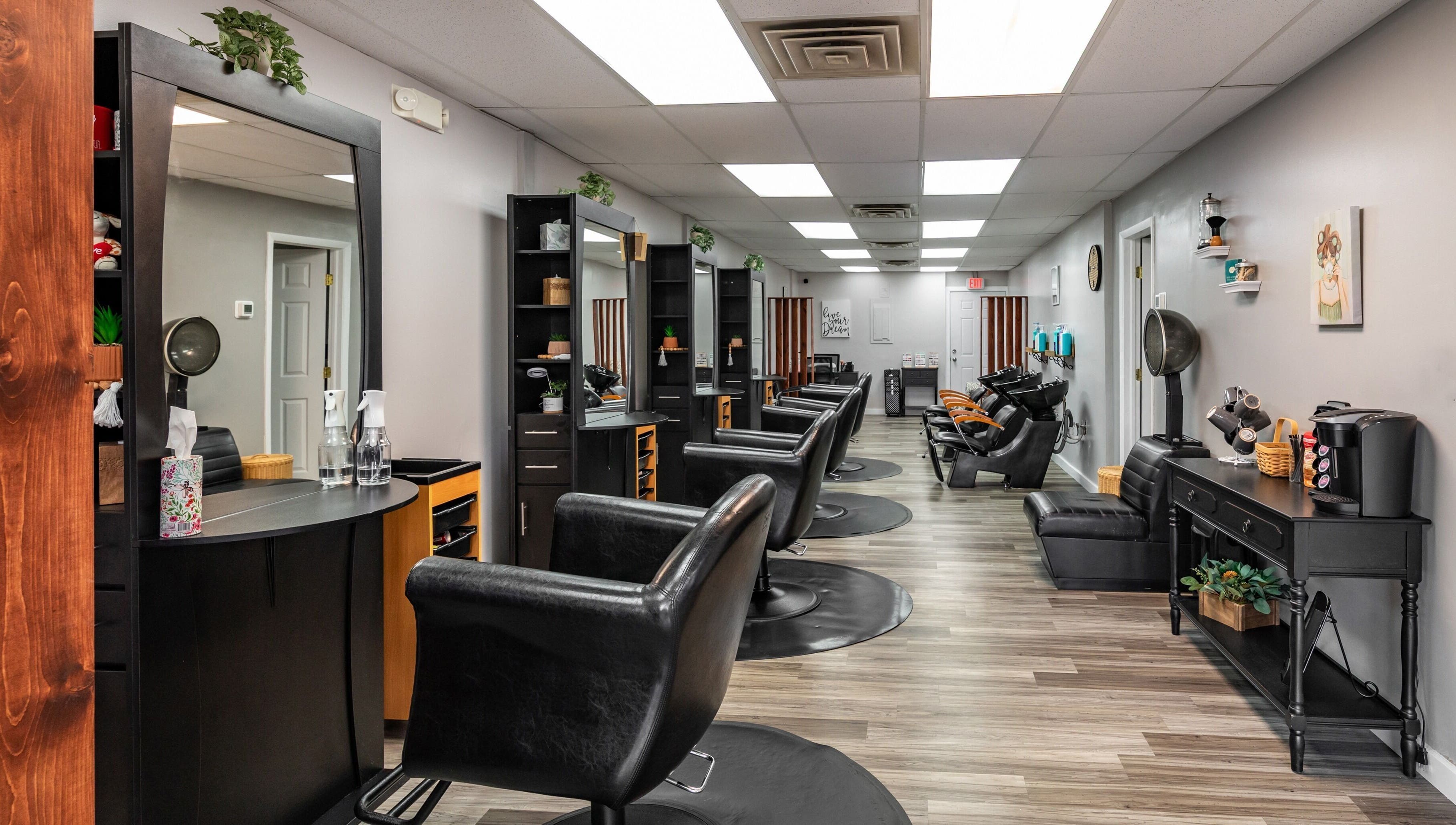 Modern salon interior at EYB Confidence Studio, Elyria, Ohio, US, showcasing elegant design and styling stations.