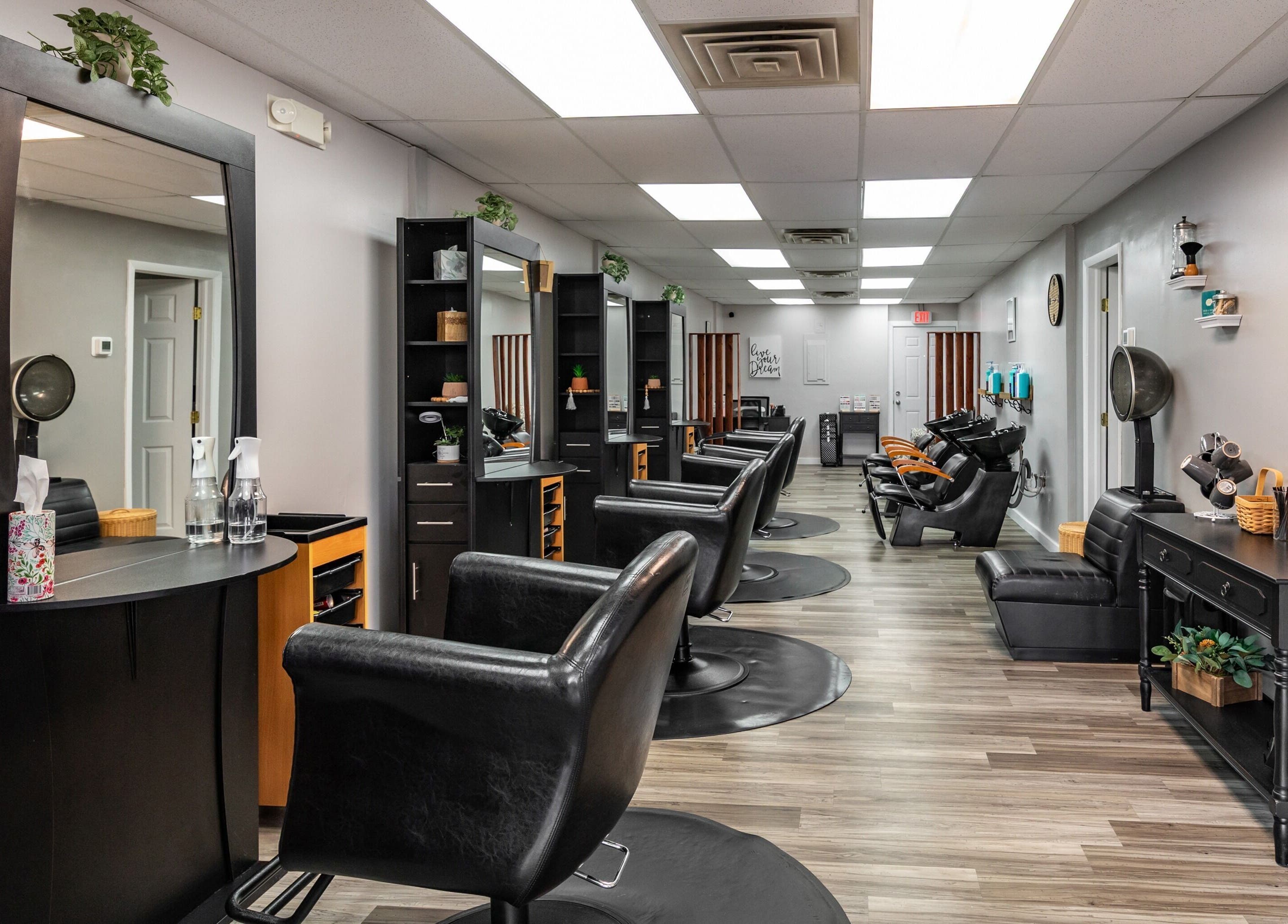 Modern salon interior at EYB Confidence Studio, Elyria, Ohio, US, showcasing elegant design and styling stations.