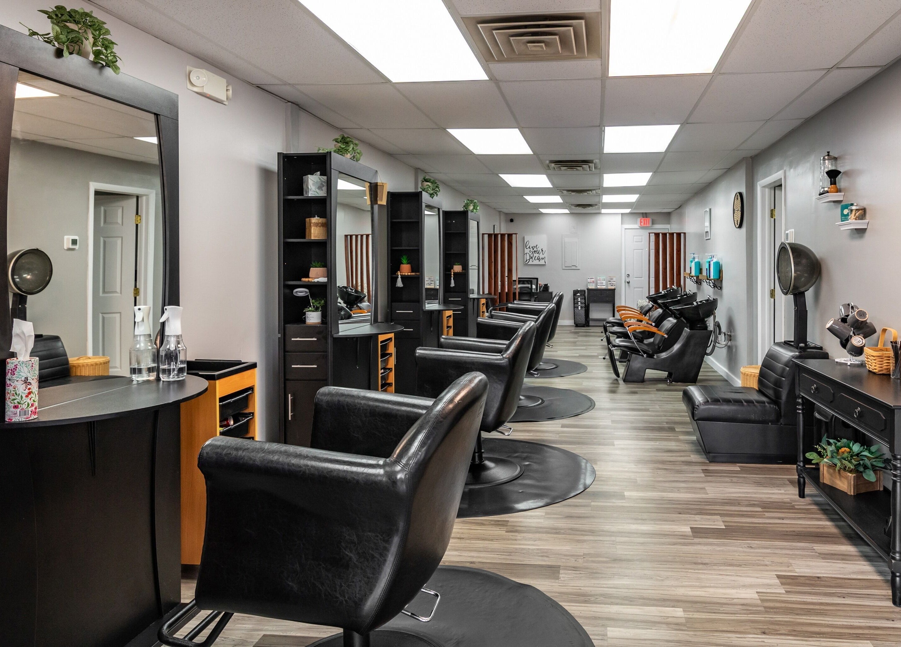 Modern salon interior at EYB Confidence Studio, Elyria, Ohio, US, showcasing elegant design and styling stations.