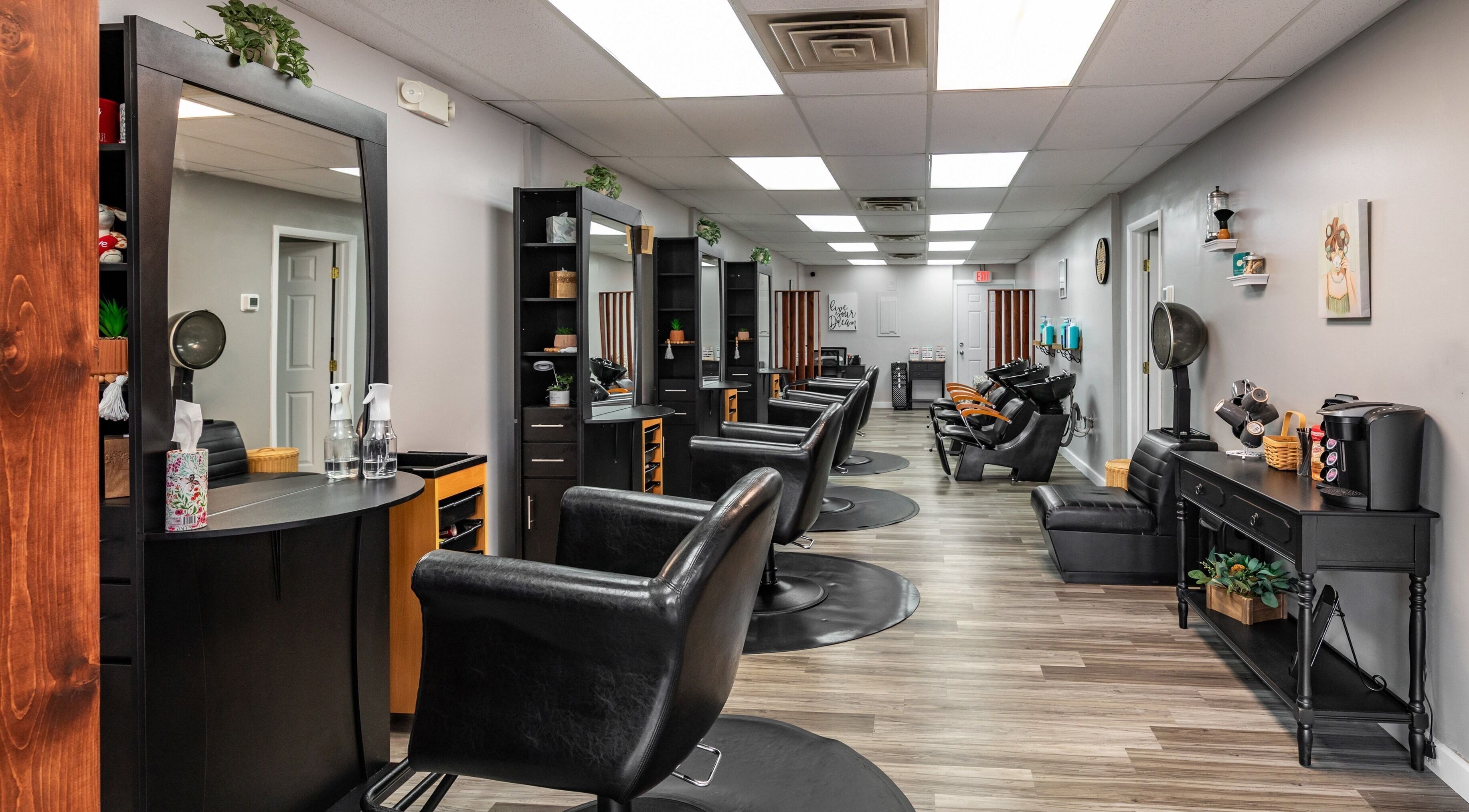 Modern salon interior at EYB Confidence Studio, Elyria, Ohio, US, showcasing elegant design and styling stations.