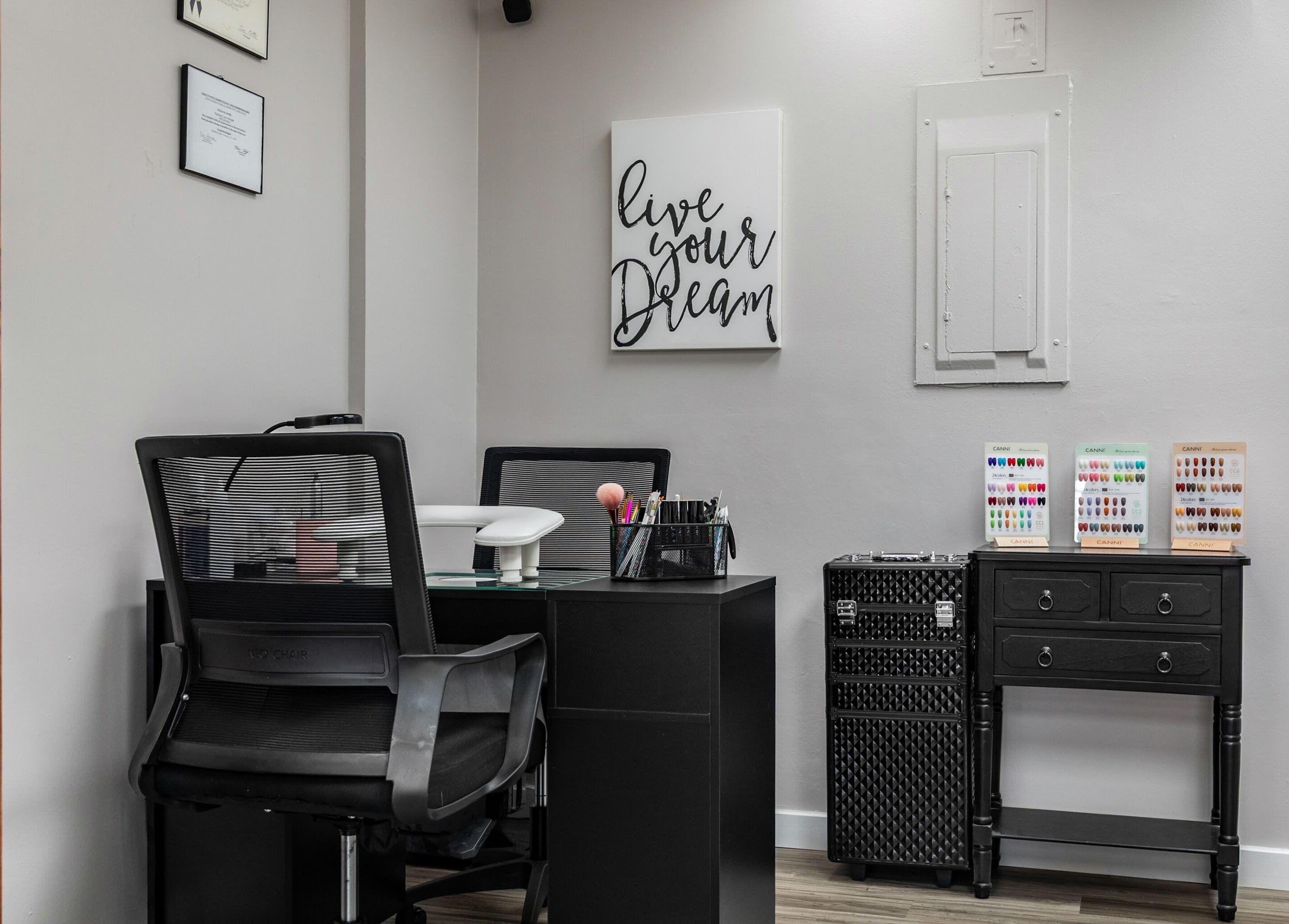 Cozy interior of EYB Confidence Studio, Elyria, Ohio, US, with nail polish samples and motivational decor.