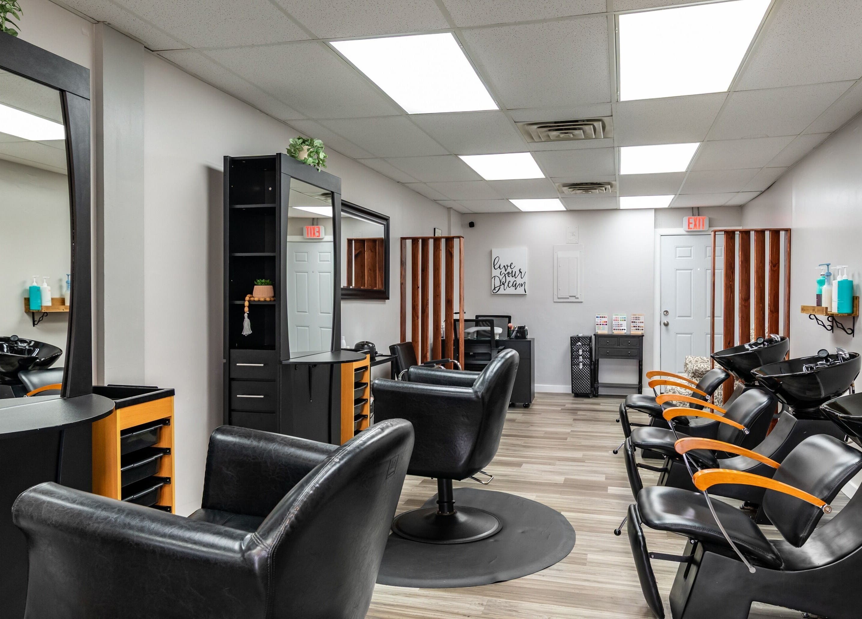 Modern salon interior at EYB Confidence Studio in Elyria, Ohio, US showcasing sleek black styling chairs.