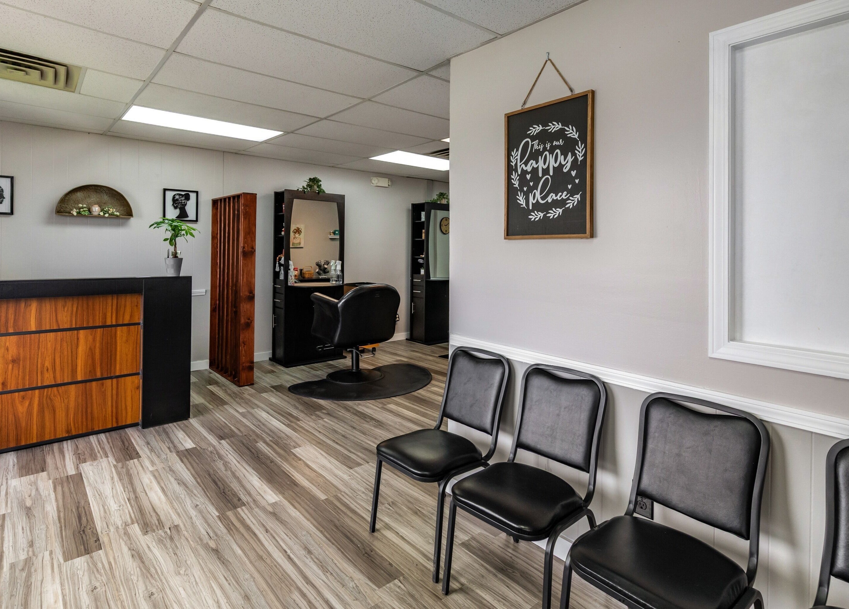 Reception area of EYB Confidence Studio in Elyria, Ohio. Modern design with chairs and a mirror.