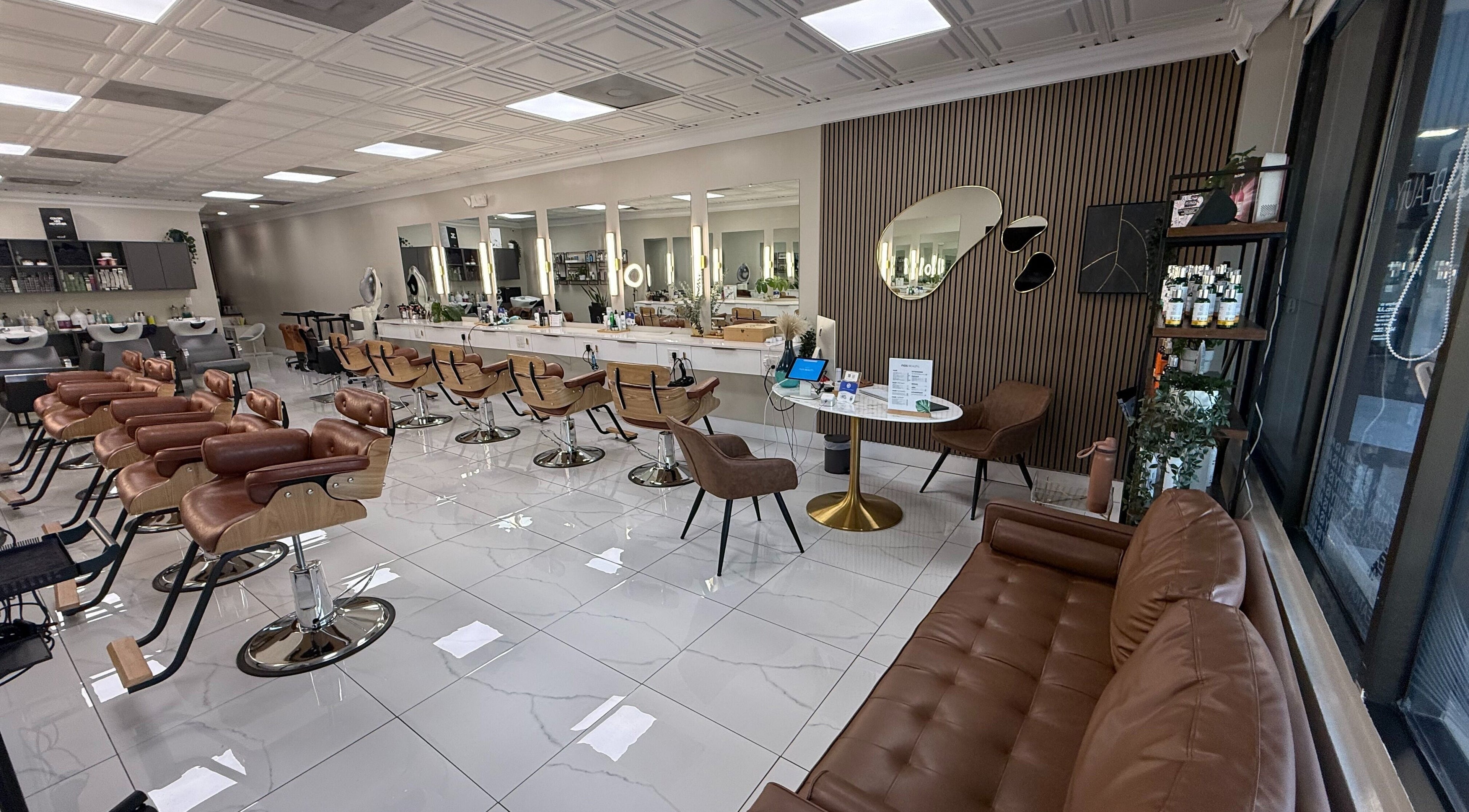 Modern interior of Fios Beauty salon, Miami, Florida, US, featuring stylish chairs and elegant decor.