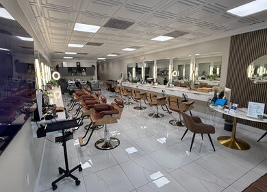 Spacious salon interior at Fios Beauty in Miami, Florida, US with stylish chairs and mirrors.