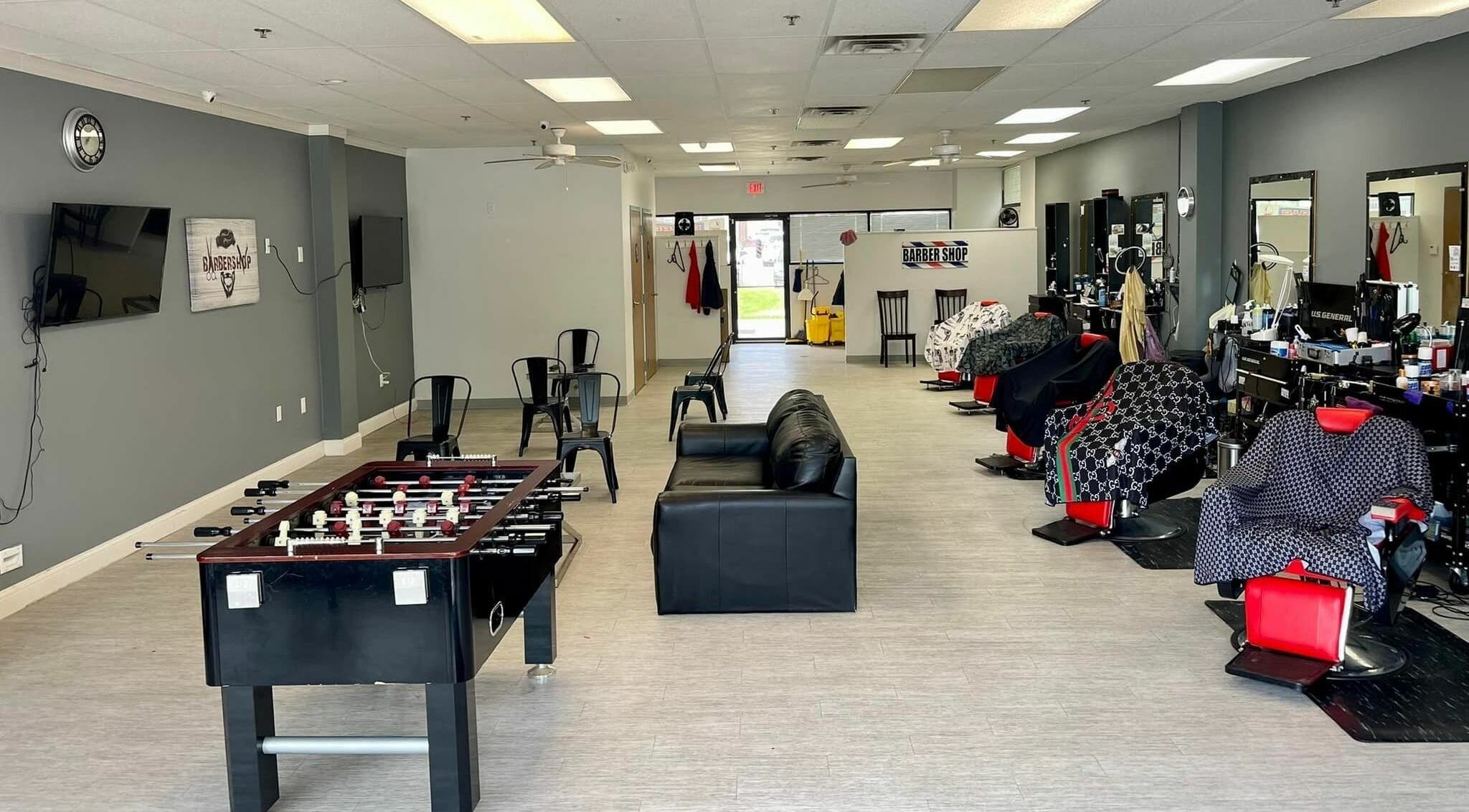 Modern interior of The Maple Barbers in Omaha, Nebraska, US, featuring stylish chairs and entertainment.