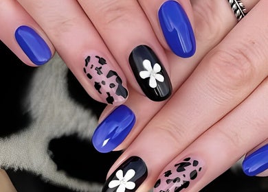 Stylish blue and floral nail art at Estelle’s Beauty Room, Rugeley, England, GB. Perfect for beauty enthusiasts.