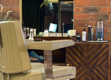 Elegant hair styling station at It's The Hair Studio, Liverpool, England, GB, featuring vintage barber chair.