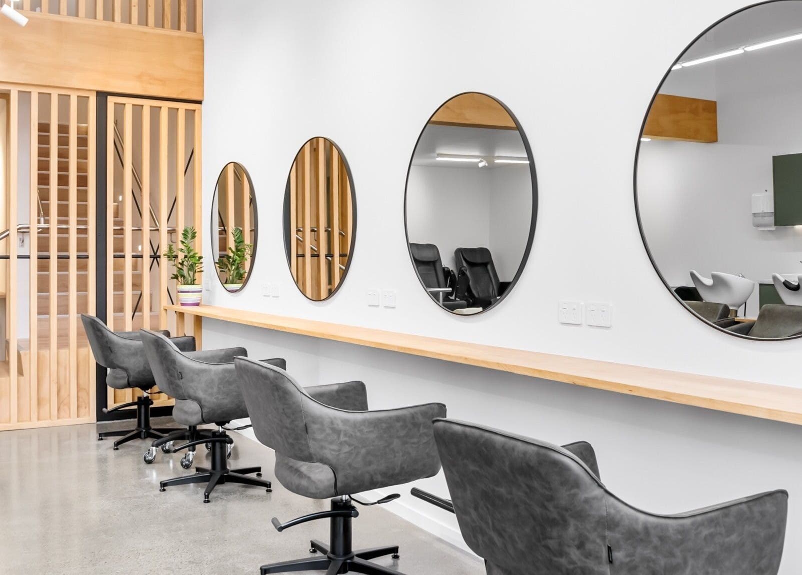 Modern salon chairs and mirrors at Beutiq, Wellington, Wellington, NZ showcasing elegant design.