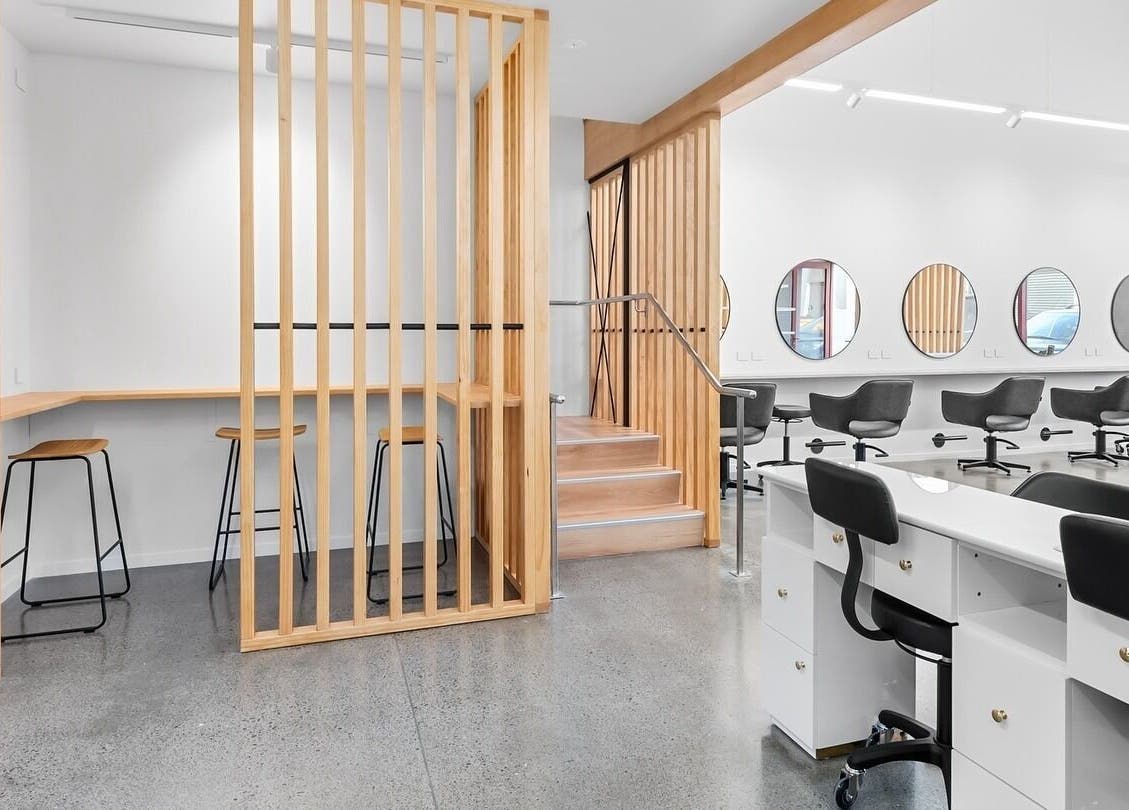 Spacious interior of Beutiq in Wellington, NZ featuring sleek salon chairs and modern design.