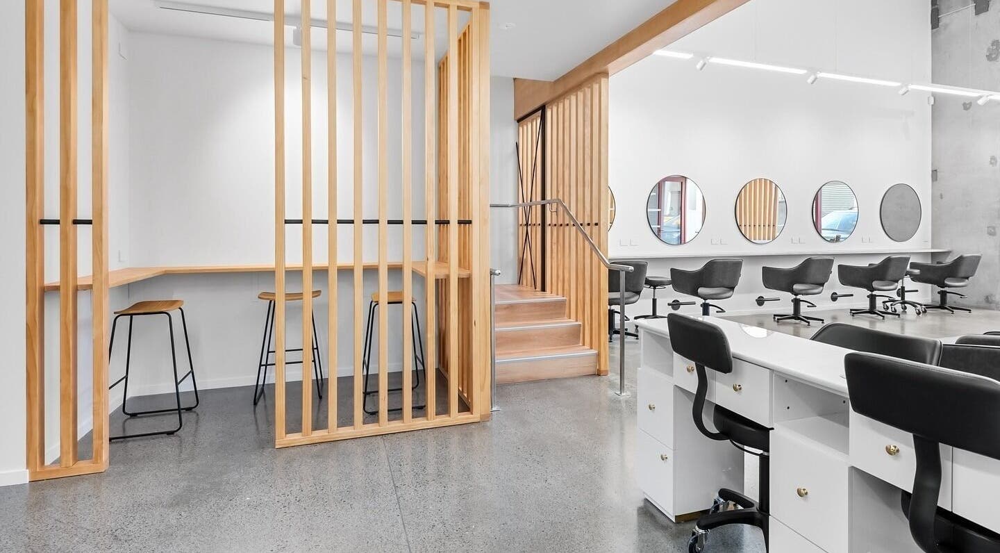 Spacious interior of Beutiq in Wellington, NZ featuring sleek salon chairs and modern design.