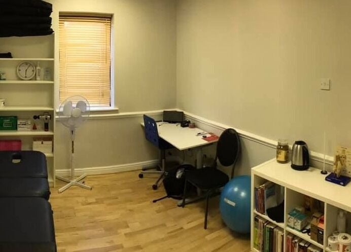 Therapy room at M20 Health & Performance, Manchester, England, GB. Features equipment, desk, and skeleton model.