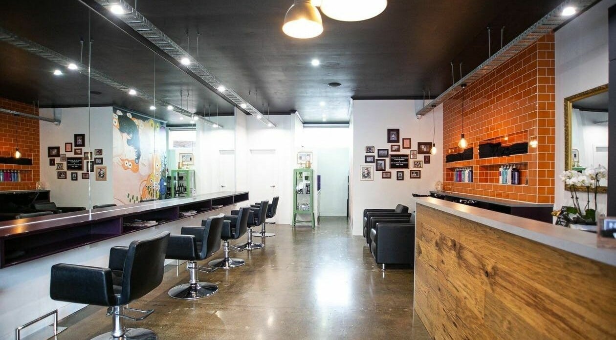 Modern salon at Indie Hair, Melbourne, Victoria, AU with sleek chairs and vibrant decor.