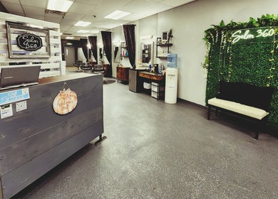 Stylish reception and seating area at Salon 360 Indy, Indianapolis, Indiana, US with greenery and decor.