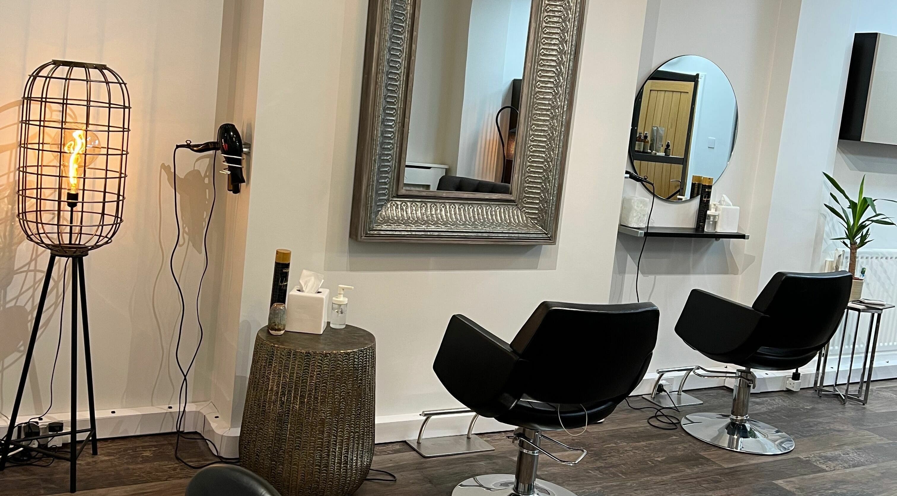 Elegant styling chairs at Tom Syed Hair Spa in Stourbridge, England, GB with mirrors and modern lighting.