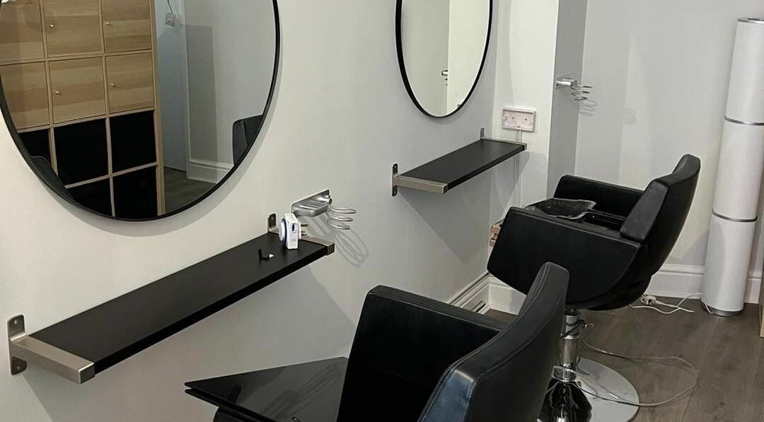 Elegant salon chairs and mirrors at Tom Syed Hair Spa, Stourbridge, England, GB, showcasing modern design.