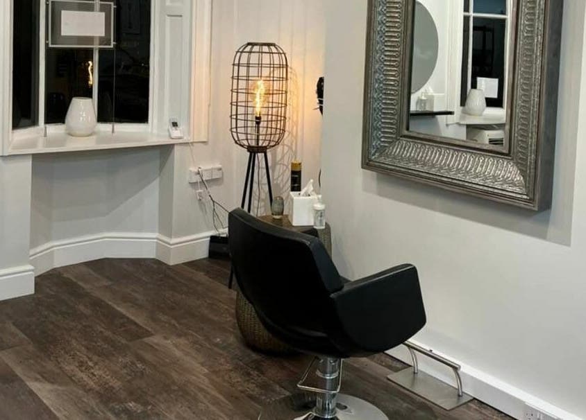 Chic interior at Tom Syed Hair Spa in Stourbridge, England, GB, featuring a stylish chair and modern decor.