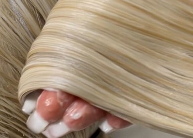 Close-up of silky blonde hair extensions from Blush Rose Hair Extensions, Melbourne, Victoria, AU.