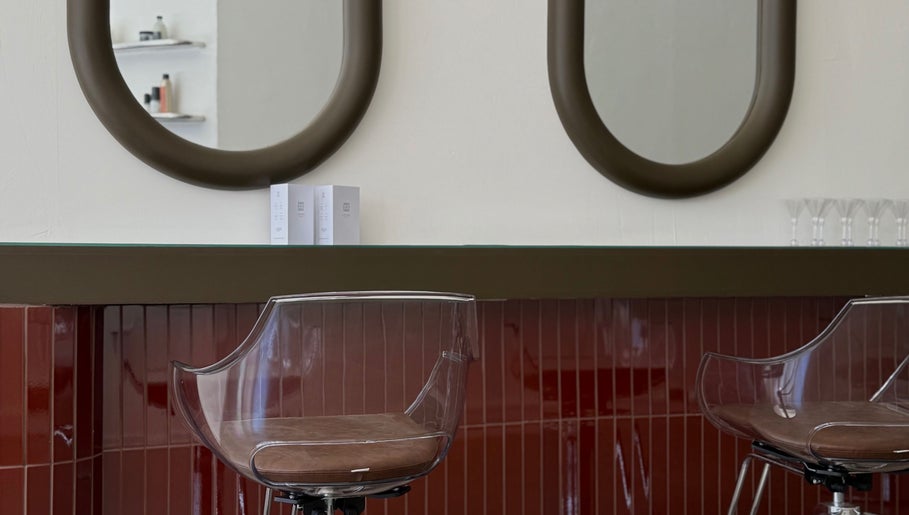 Elegant styling area at Cuttlefish Eco Salon - Worthing, featuring modern mirrors and sleek chairs. Worthing, England, GB.