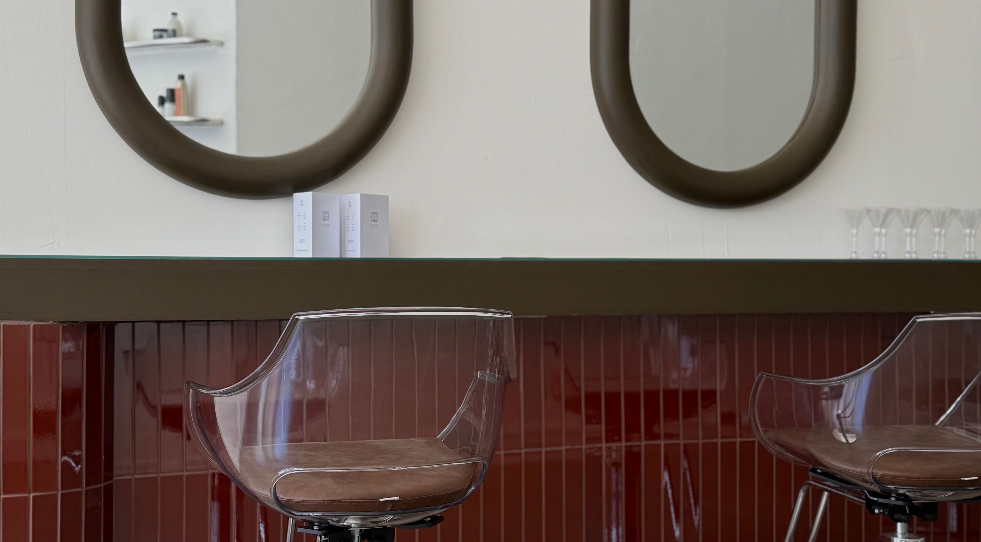 Elegant styling area at Cuttlefish Eco Salon - Worthing, featuring modern mirrors and sleek chairs. Worthing, England, GB.