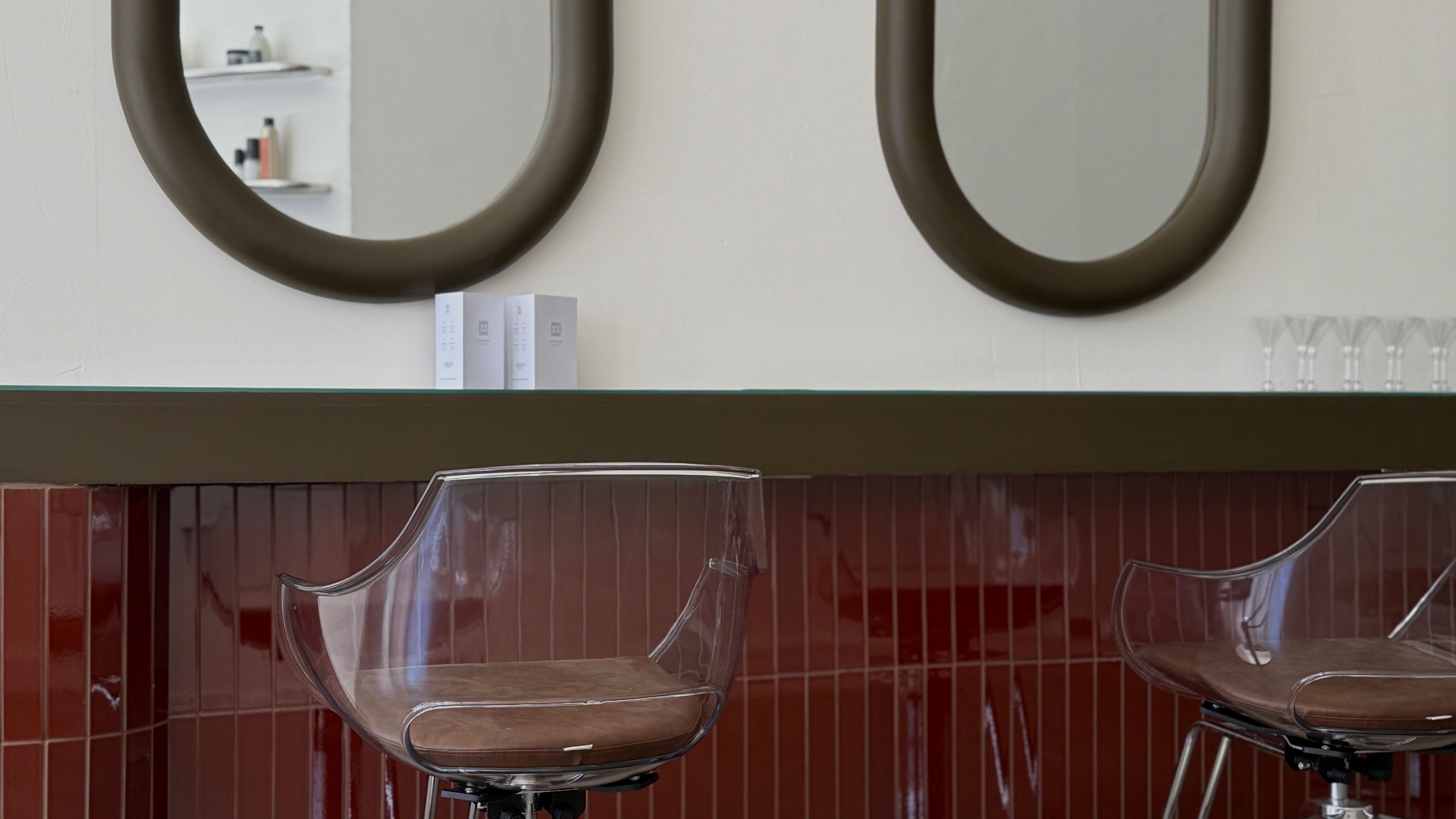 Elegant styling area at Cuttlefish Eco Salon - Worthing, featuring modern mirrors and sleek chairs. Worthing, England, GB.