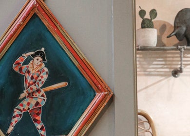 Artistic wall decor at Cuttlefish Eco Salon - Lewes, featuring a colorful harlequin painting, Lewes, England, GB.