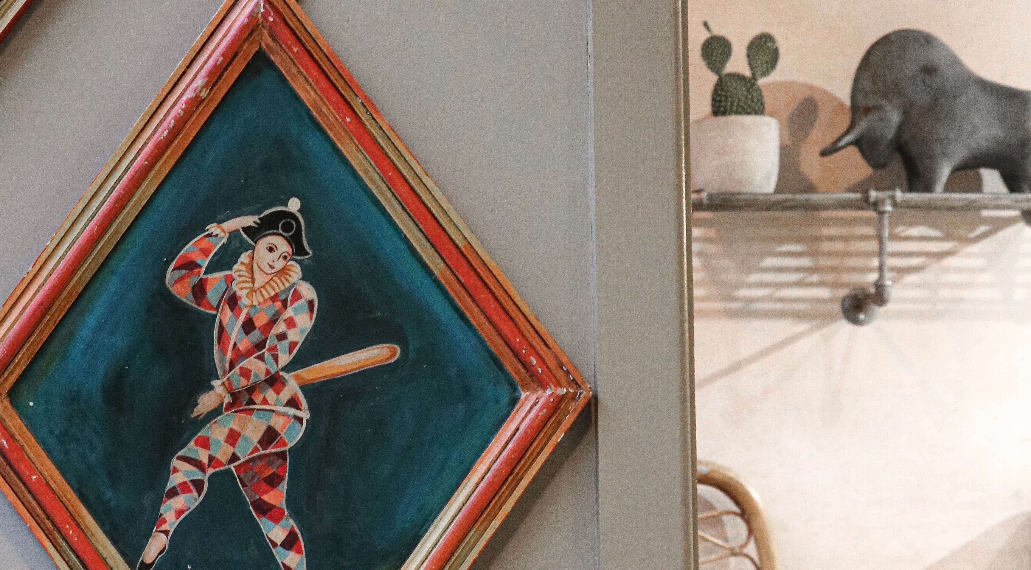 Artistic wall decor at Cuttlefish Eco Salon - Lewes, featuring a colorful harlequin painting, Lewes, England, GB.