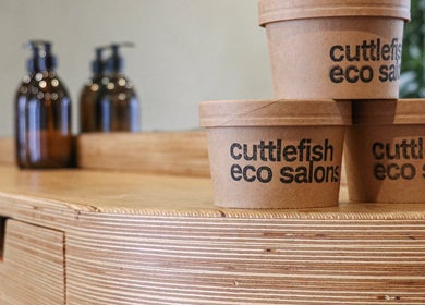 Brown cardboard cups at Cuttlefish Eco Salon - Brighton reflecting sustainable practices, Brighton, England, GB.