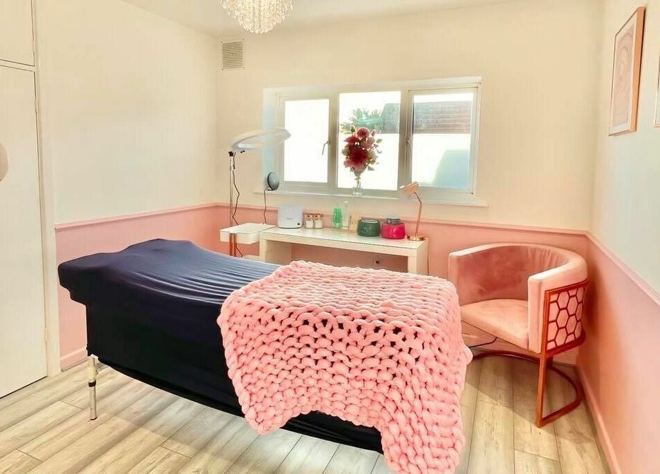 Relaxing treatment room at The Beauty Studio, Hayling Island, England, GB, featuring cozy pink decor.