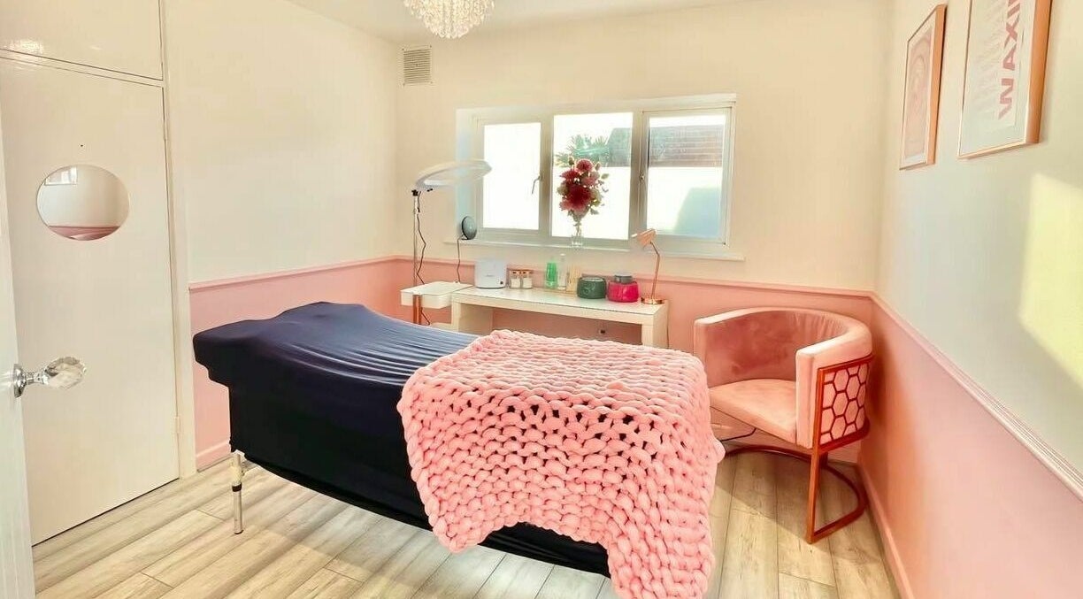 Relaxing treatment room at The Beauty Studio, Hayling Island, England, GB, featuring cozy pink decor.