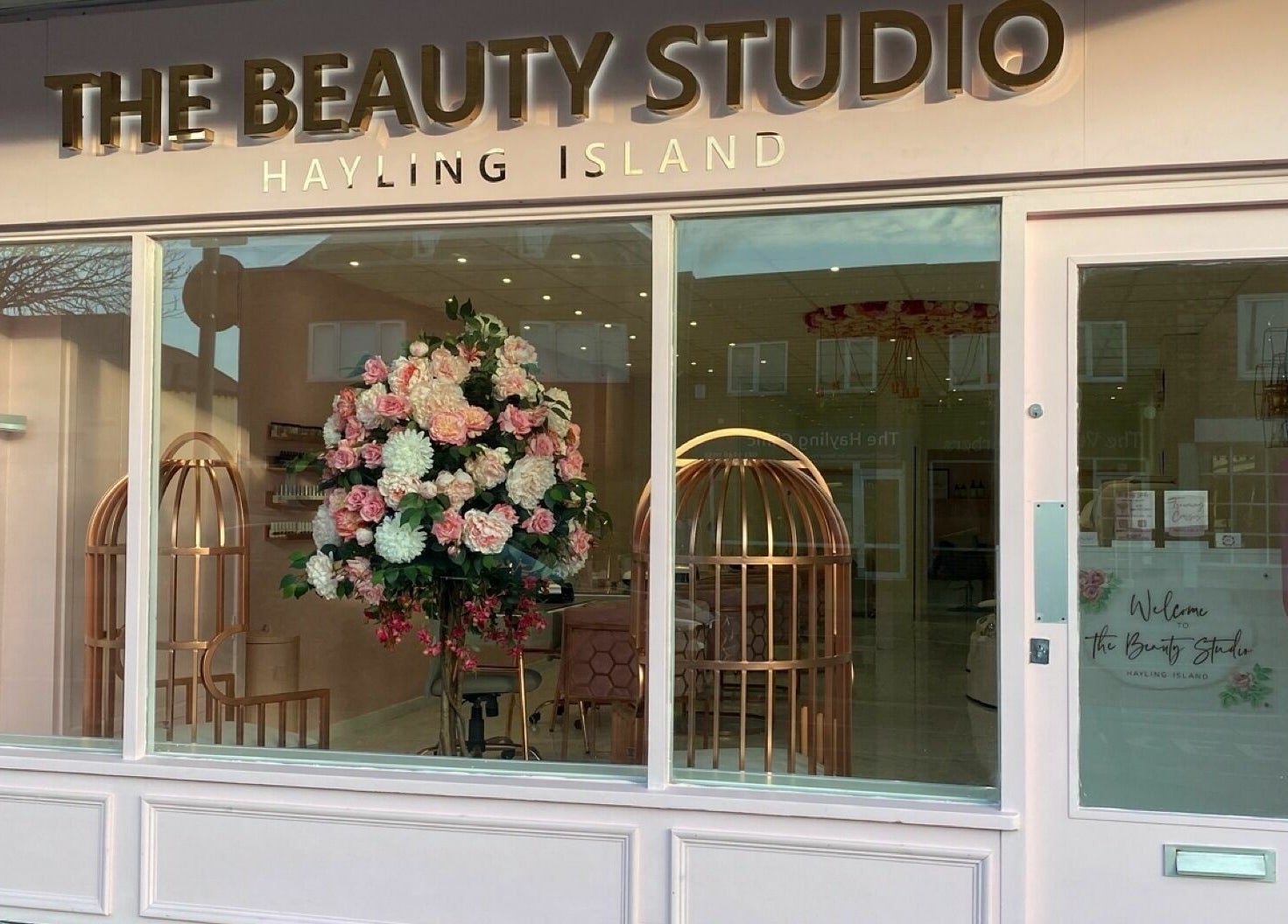 Front view of The Beauty Studio on Hayling Island, England, GB, showcasing floral decor and modern design.