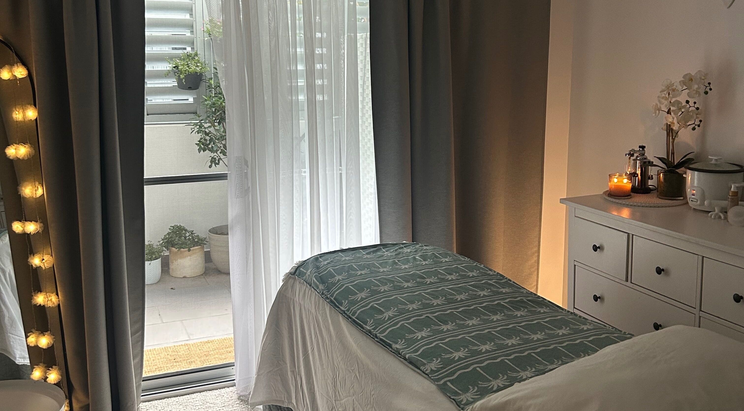 Cozy treatment room at Society Isle Beauty and Wellbeing in Bulimba, Queensland, AU, with ambient lighting.