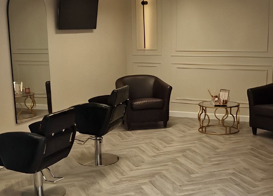 Modern salon seating at Omree Laser and Aesthetics, Stoke-on-Trent, England, GB; elegant chairs and coffee table.