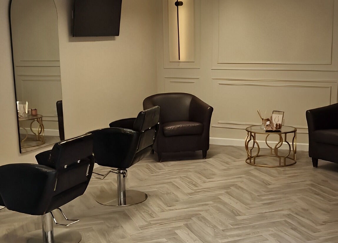 Modern salon seating at Omree Laser and Aesthetics, Stoke-on-Trent, England, GB; elegant chairs and coffee table.