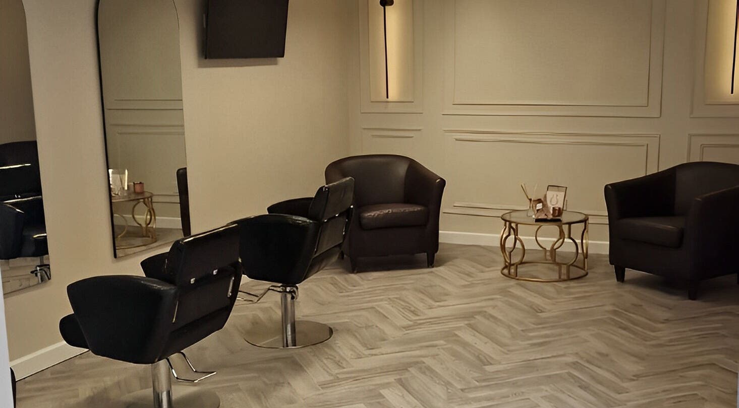 Modern salon seating at Omree Laser and Aesthetics, Stoke-on-Trent, England, GB; elegant chairs and coffee table.